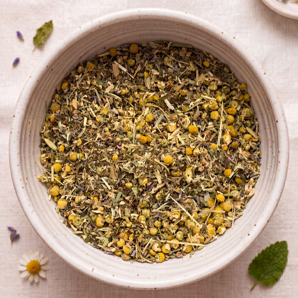White bowl filled with dried herbs and flowers on a light background